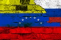 Flag of Venezuela and Russia on the background of a brick wall with broken plaster