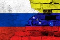 Flag of Venezuela and Russia on the background of a brick wall with broken plaster