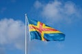 Flag of Ãâ¦lands, Finland against a blue sky. Royalty Free Stock Photo