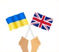 Hands holding British and Ukrainian flag. Royalty Free Stock Photo