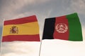 Flags of Afghanistan and Spain waving with cloudy blue sky background, 3D rendering