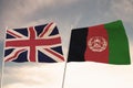 Flags of Afghanistan and United Kingdom UK waving with cloudy blue sky background, 3D rendering