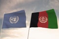 Flags of Afghanistan and United Nations UN waving with cloudy blue sky background, 3D rendering