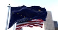 The flags of the Alaska state and United States of America waving in the wind. Democracy and independence. American state.