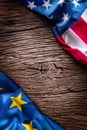 Flags of american and european union on rustic oak board. EU and USA flags together diagonally Royalty Free Stock Photo