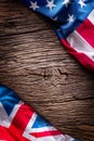 Flags of american and united kingdom on rustic oak board. UK and USA flags together diagonally Royalty Free Stock Photo