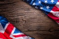 Flags of american and united kingdom on rustic oak board. UK and USA flags together diagonally Royalty Free Stock Photo