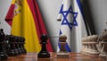 Flags of Spain and Israel behind pawns on the chessboard. Chess game or political rivalry related 3D rendering