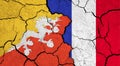 Flags of Bhutan and France on cracked surface
