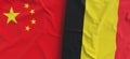 Flags of China and Belgium. Linen flag close-up. Flag made of canvas. Chinese flag. Beijing. Belgian. State national symbols. 3d