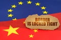 On the flags of China and the European Union lies a cardboard plate with the inscription - Border is locked tight Royalty Free Stock Photo