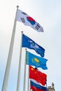 Flags of China, Kazakhstan, South Korea, Russia and Commonwealth of Independent States on the background of cloudy sky Royalty Free Stock Photo