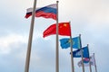 Flags of China, Kazakhstan, South Korea, Russia and Commonwealth of Independent States on the background of cloudy sky Royalty Free Stock Photo