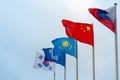 Flags of China, Kazakhstan, South Korea, Russia and Commonwealth of Independent States on the background of cloudy sky Royalty Free Stock Photo