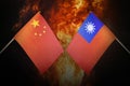 Flags of china and taiwan against background of a fiery explosion. The concept of enmity and war between countries