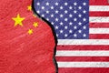 Flags of China and the United States of America on a cement plaster of a cracked wall as a concept of escalation and tension in