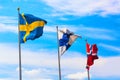 The flags of the countries of Scandinavia Sweden, Finland and Norway waving in the blue sky during beautiful summer day