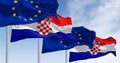 The flags of Croatia and the European Union fluttering together on a clear day Royalty Free Stock Photo