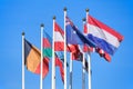 Flags of different countries against a blue sky Royalty Free Stock Photo