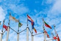 Flags of different countries on blue sky background Royalty Free Stock Photo