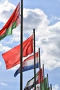 Flags of different countries at blue sky background Royalty Free Stock Photo