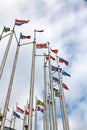 Flags of different countries on cloudy sky background Royalty Free Stock Photo