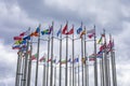 Flags of different countries fluttering in the wind, a ring of national flags against a blue sky Royalty Free Stock Photo
