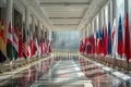 The flags of diverse nations line the spacious corridor of a diplomatic building, reflecting the solemnity and respect