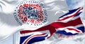 Flags with the emblem of the coronation of King Charles III and of UK waving Royalty Free Stock Photo