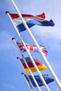 Flags from England, United Kingdom, Germany and Nederlands waving from flagpoles together with the EU, European Union, flag agains