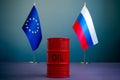 Flags of the EU and Russia and a barrel of oil as a symbol of sanctions.