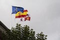 Flags of Europe, Spain and castile and lion waving in the wind over a cloudy sky