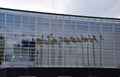 flags of European countries reflected in the glass face of the eu parliament