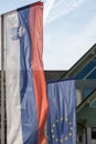 Flags of the European Union and Slovenia waiving together in the Slovenian capital city, Ljubljana.