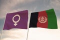 Flags of feminists and the Afghanistan waving behind cloudy skies