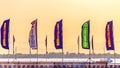 the flags of football sponsors flutter in the wind against the backdrop of an unsettling sky and the Volga River