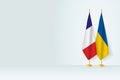 Flags of France and Ukraine on flag stand, meeting between two countries