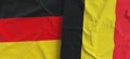 Flags of Germany and Belgium. Linen flag close-up. Flag made of canvas. German, Berlin. Belgian. State national symbols. 3d