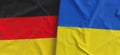 Flags of Germany and Ukraine. Linen flag close-up. Flag made of canvas. German, Berlin. Ukrainian. State national symbols. 3d Royalty Free Stock Photo