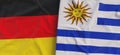 Flags of Germany and Uruguay. Linen flag close-up. Flag made of canvas. German, Berlin. Montevideo. State national symbols. 3d