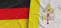 Flags of Germany and Vatican. Linen flags close-up. Flag made of canvas. German, Berlin. The Holy Throne. State national symbols.