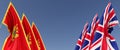 Flags of Great Britain and Montenegro on flagpoles on sides. Flags on a blue background. England, United Kingdom. Podgorica, the