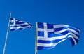 Flags of Greece Flying in Wind and Blue Sky Royalty Free Stock Photo