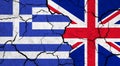 Flags of Greece and United Kingdom on cracked surface