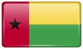 Flags GuineaBissau in the form of a magnet on refrigerator with reflections light. Royalty Free Stock Photo