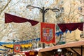 flags hung on a festive day at the medieval market. heraldic shields on some hangings at a street fair.