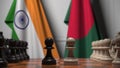 Flags of India and Bangladesh behind pawns on the chessboard. Chess game or political rivalry related 3D rendering