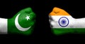 Flags of India and Pakistan painted on two clenched fists facing