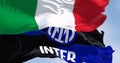 Flags of Inter football club and Italy waving in the wind on a clear day