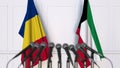 Flags of Romania and Kuwait at international meeting or negotiations press conference. 3D rendering Royalty Free Stock Photo
